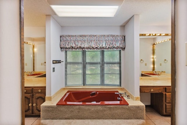 1300 Woodland Trail Dr, Bowie, TX 76230 - bathroom featuring tile patterned floors, a garden tub, vanity, and a textured ceiling