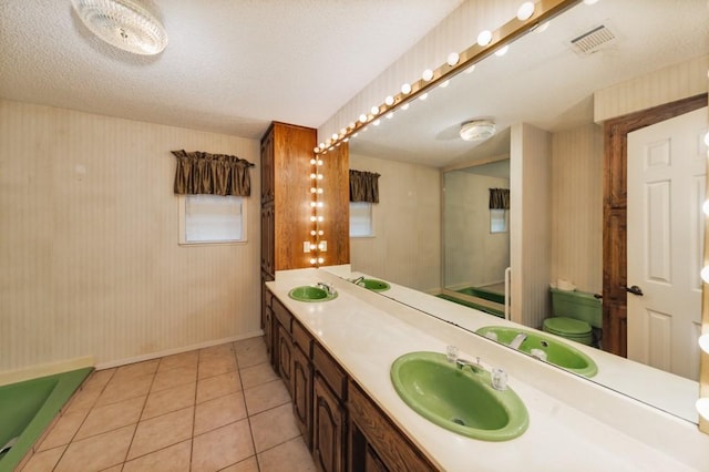 1300 Woodland Trail Dr, Bowie, TX 76230 - full bathroom featuring baseboards, double vanity, tile patterned floors, wallpapered walls, and toilet