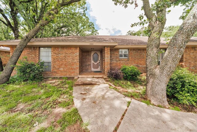 1300 Woodland Trail Dr, Bowie, TX 76230 - single story home featuring brick siding