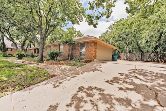 1300 Woodland Trail Dr, Bowie, TX 76230 - view of front of house featuring brick siding, fence, driveway, and a garage
