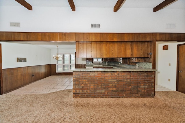 1300 Woodland Trail Dr, Bowie, TX 76230 - kitchen featuring beamed ceiling, light colored carpet, light tile patterned floors, a chandelier, and tasteful backsplash