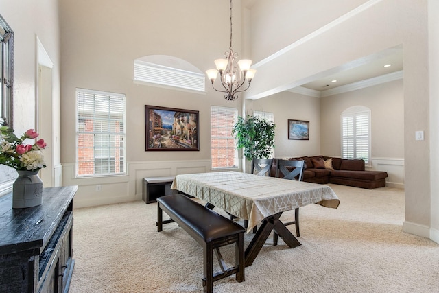 2048 Remington Ln, Frisco, TX 75033 - carpeted dining room featuring a chandelier, a high ceiling, wainscoting, and crown molding