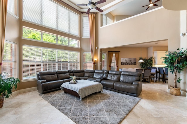 2048 Remington Ln, Frisco, TX 75033 - living area featuring ceiling fan, a towering ceiling, light tile patterned floors, and plenty of natural light