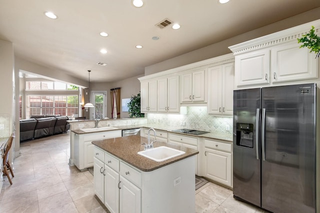 2048 Remington Ln, Frisco, TX 75033 - kitchen featuring appliances with stainless steel finishes, a sink, a peninsula, recessed lighting, and white cabinets
