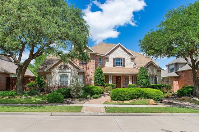 2048 Remington Ln, Frisco, TX 75033 - traditional-style home featuring stone siding and fence