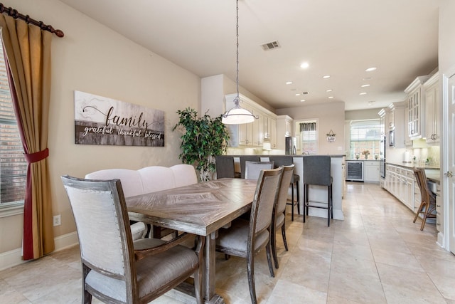 2048 Remington Ln, Frisco, TX 75033 - dining area with beverage cooler, recessed lighting, light tile patterned floors, and baseboards