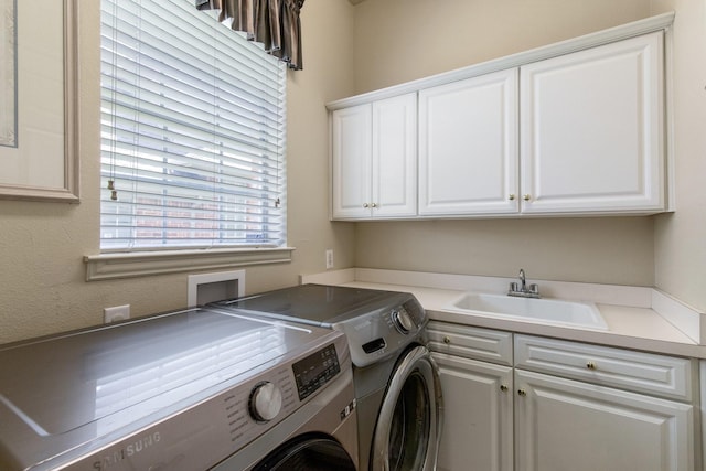 2048 Remington Ln, Frisco, TX 75033 - clothes washing area featuring washer and clothes dryer and cabinet space