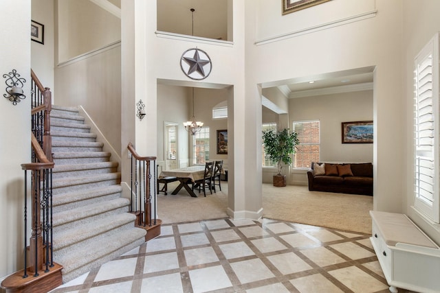2048 Remington Ln, Frisco, TX 75033 - entryway with light carpet, stairs, plenty of natural light, a high ceiling, and crown molding