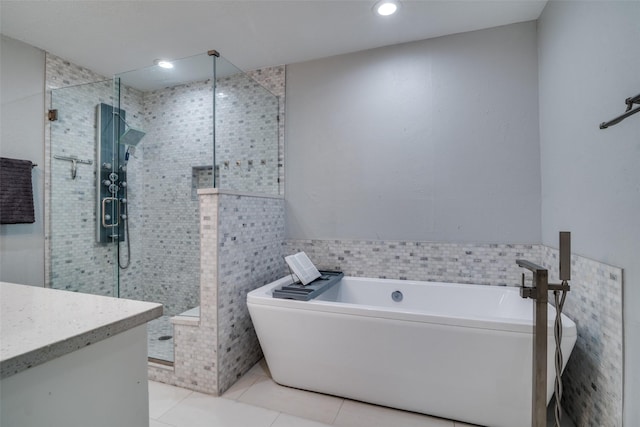 1301 Windy Meadow Dr, Plano, TX 75023 - full bath with tile patterned floors, a freestanding tub, a shower stall, vanity, and tile walls