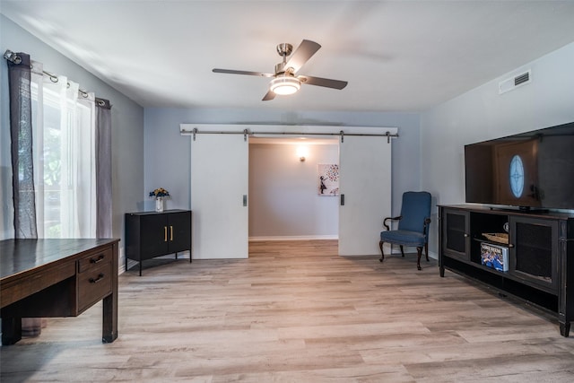 1301 Windy Meadow Dr, Plano, TX 75023 - living area featuring a barn door, light wood-style floors, and a ceiling fan