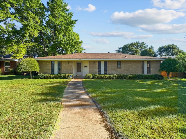 ranch-style house with brick siding and a front lawn