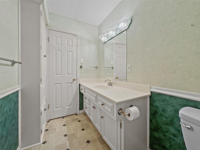 bathroom with toilet and vanity