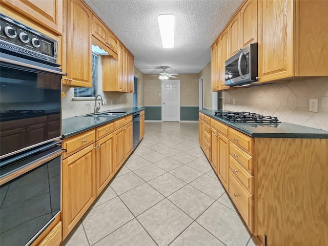 kitchen with black appliances, dark countertops, baseboards, decorative backsplash, and a textured ceiling