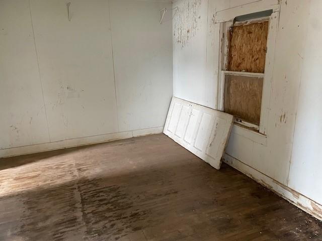 unfurnished room with wood finished floors