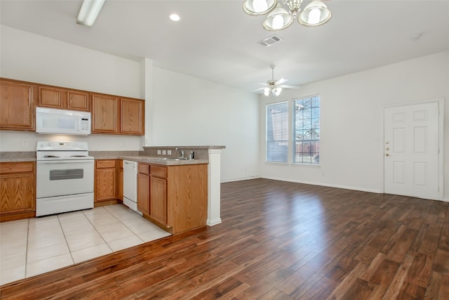 1727 Preston On The Lake Blvd, Little Elm, TX 75068 - kitchen featuring white appliances, a sink, a peninsula, a chandelier, and light wood finished floors
