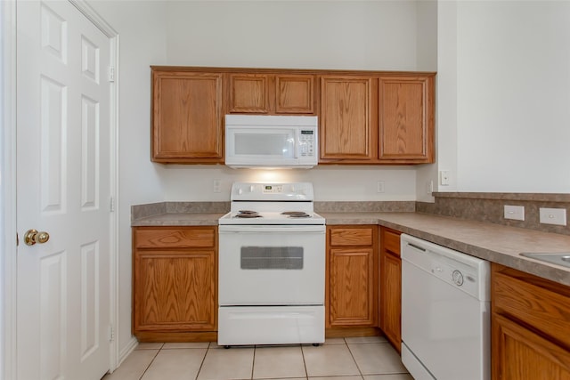 1727 Preston On The Lake Blvd, Little Elm, TX 75068 - kitchen featuring white appliances, brown cabinets, and light tile patterned floors