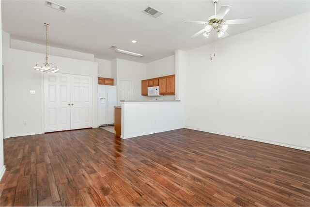 1727 Preston On The Lake Blvd, Little Elm, TX 75068 - unfurnished living room featuring dark wood finished floors, a ceiling fan, a chandelier, baseboards, and recessed lighting