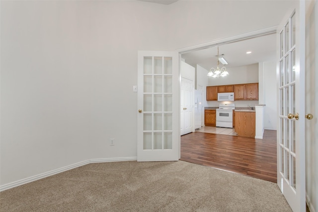 1727 Preston On The Lake Blvd, Little Elm, TX 75068 - unfurnished living room with french doors, a chandelier, light colored carpet, baseboards, and a sink