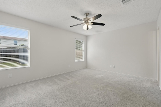 3110 Legend Dr, Mckinney, TX 75070 - unfurnished room featuring plenty of natural light, carpet floors, a ceiling fan, a textured ceiling, and baseboards