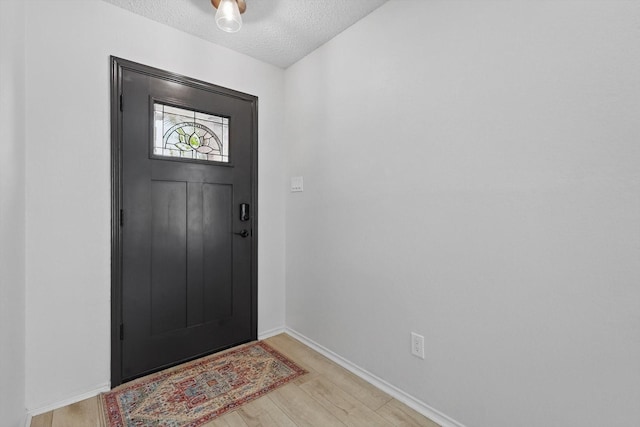 3110 Legend Dr, Mckinney, TX 75070 - entrance foyer featuring light wood-type flooring, a textured ceiling, and baseboards