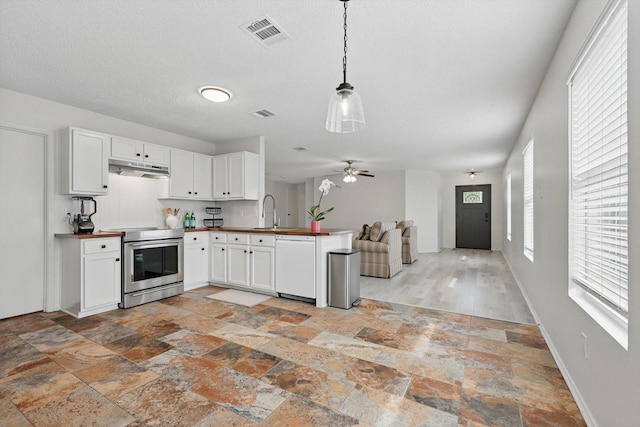 3110 Legend Dr, Mckinney, TX 75070 - kitchen featuring stainless steel range with electric cooktop, white dishwasher, a peninsula, open floor plan, and stone tile flooring