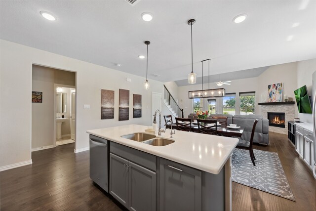 216 Shadow Creek Ln, Hickory Creek, TX 75065 - kitchen featuring a sink, stainless steel dishwasher, a fireplace, light countertops, and dark wood finished floors