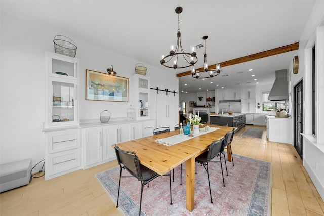 1197 Prairie Chapel Rd, Crawford, TX 76638 - dining space with light wood finished floors, a chandelier, a barn door, and recessed lighting