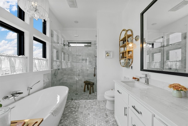 1197 Prairie Chapel Rd, Crawford, TX 76638 - full bath with toilet, a shower stall, vanity, a freestanding tub, and tile patterned floors