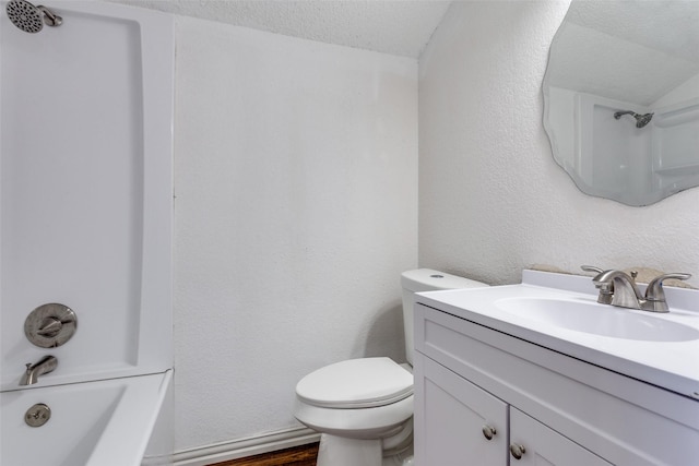 bathroom featuring toilet, vanity, bathing tub / shower combination, wood finished floors, and a textured ceiling