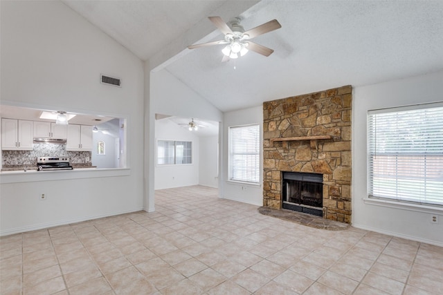 unfurnished living room featuring a ceiling fan, a fireplace, high vaulted ceiling, light tile patterned floors, and beam ceiling