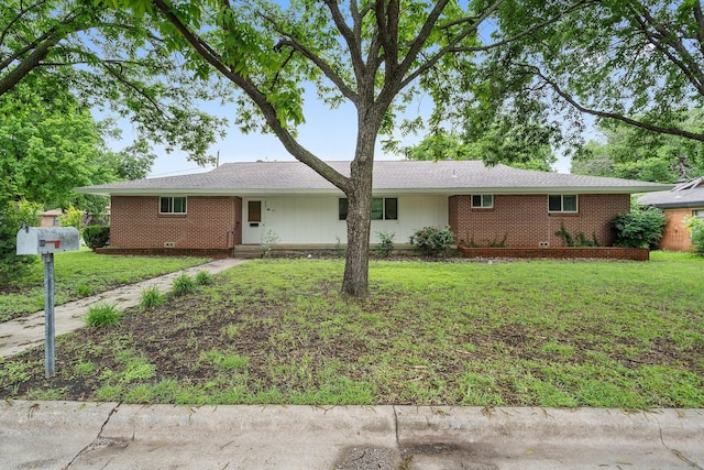 ranch-style home with a front lawn and brick siding