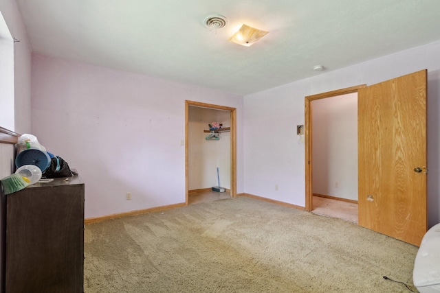unfurnished bedroom featuring carpet floors and baseboards