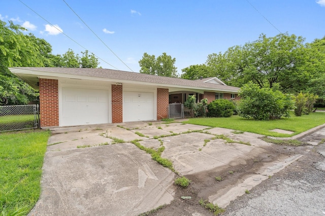 ranch-style house featuring concrete driveway, an attached garage, brick siding, and roof with shingles