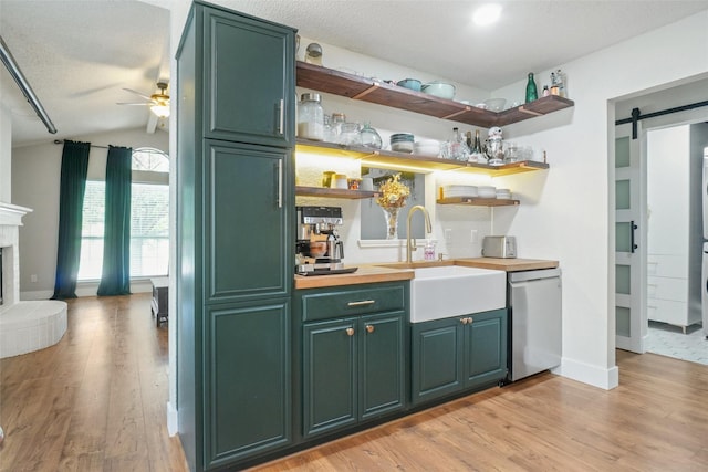 5012 Marina Del Rd, Fort Worth, TX 76179 - indoor bar featuring stainless steel dishwasher, ceiling fan, light wood-style flooring, a barn door, and vaulted ceiling