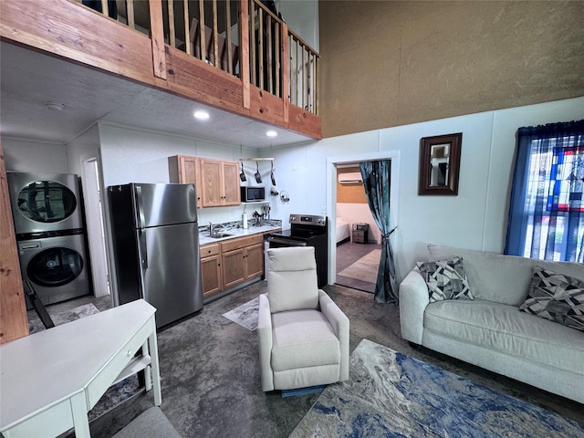 235 Hcr 2128, Whitney, TX 76692 - living room with estacked washer and dryer, a high ceiling, concrete floors, and an AC wall unit