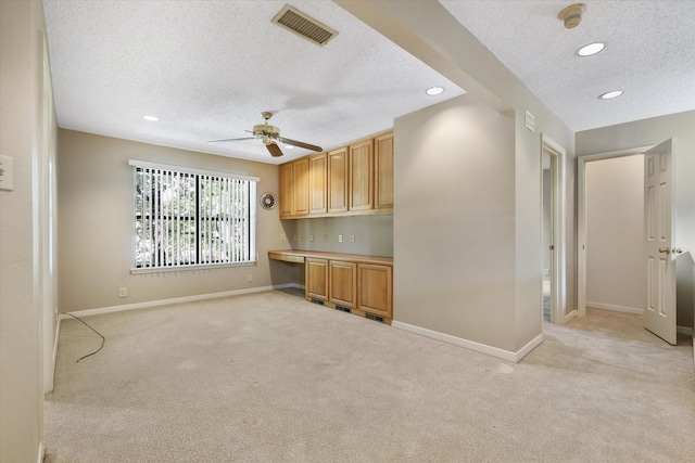 kitchen featuring light colored carpet, a textured ceiling, baseboards, ceiling fan, and recessed lighting
