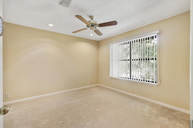 carpeted spare room featuring a ceiling fan, a textured ceiling, baseboards, and recessed lighting