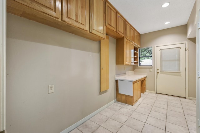 kitchen with light countertops, baseboards, light tile patterned floors, recessed lighting, and open shelves