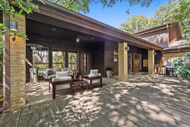 wooden terrace featuring outdoor lounge area and a grill