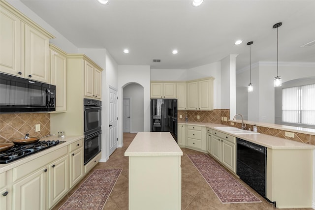 473 Inverness Dr, Fairview, TX 75069 - kitchen featuring cream cabinets, black appliances, a sink, arched walkways, and recessed lighting
