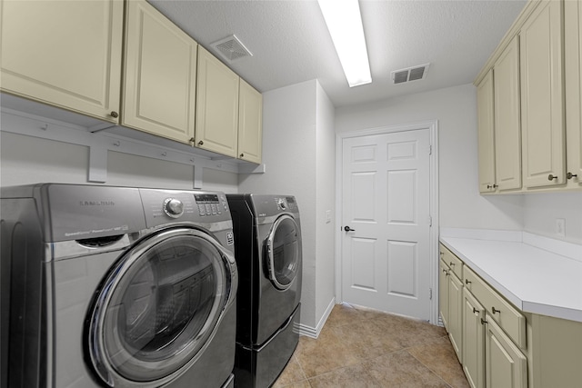 473 Inverness Dr, Fairview, TX 75069 - clothes washing area with washing machine and dryer, cabinet space, a textured ceiling, light tile patterned flooring, and baseboards