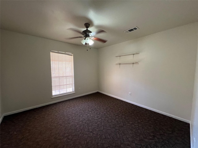 216 E Homewood Dr, Crockett, TX 75835 - empty room featuring ceiling fan, dark carpet, and baseboards