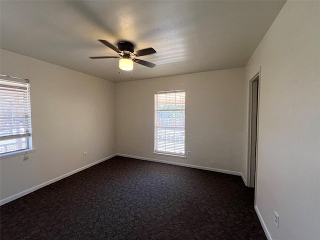 216 E Homewood Dr, Crockett, TX 75835 - spare room with healthy amount of natural light, ceiling fan, and dark colored carpet