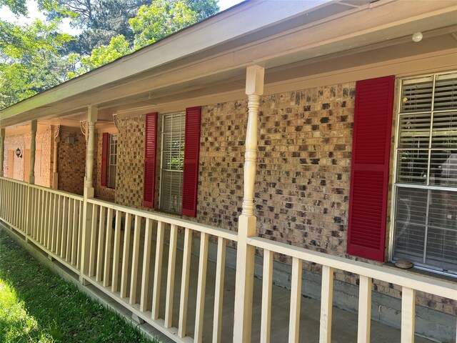 216 E Homewood Dr, Crockett, TX 75835 - view of property exterior featuring brick siding and a porch
