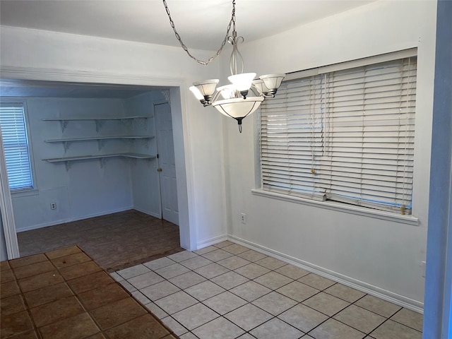 216 E Homewood Dr, Crockett, TX 75835 - unfurnished dining area featuring a chandelier and baseboards