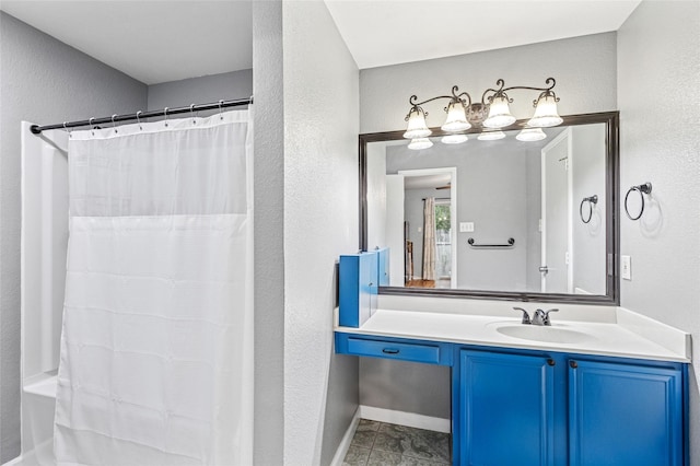 6405 Longmont Trl, Fort Worth, TX 76179 - full bathroom featuring a textured wall, vanity, a shower with shower curtain, baseboards, and tile patterned flooring