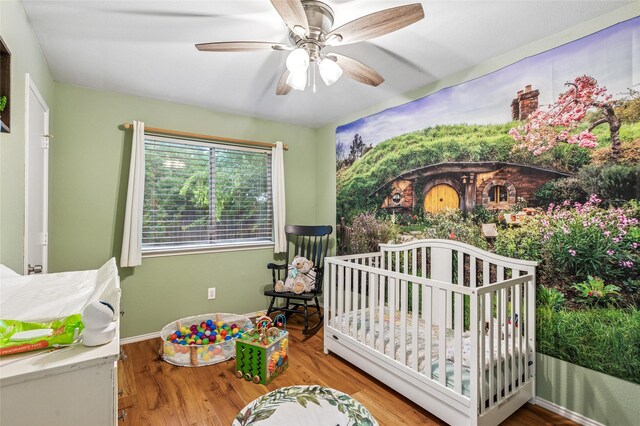 6405 Longmont Trl, Fort Worth, TX 76179 - bedroom with a crib, wood finished floors, a ceiling fan, and baseboards