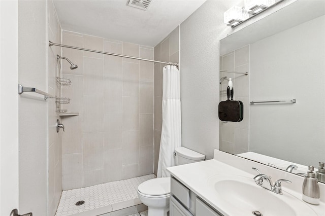 6405 Longmont Trl, Fort Worth, TX 76179 - bathroom with toilet, vanity, and a tile shower