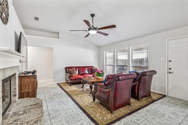 6405 Longmont Trl, Fort Worth, TX 76179 - living room with lofted ceiling, a ceiling fan, light marble finish flooring, and a tiled fireplace