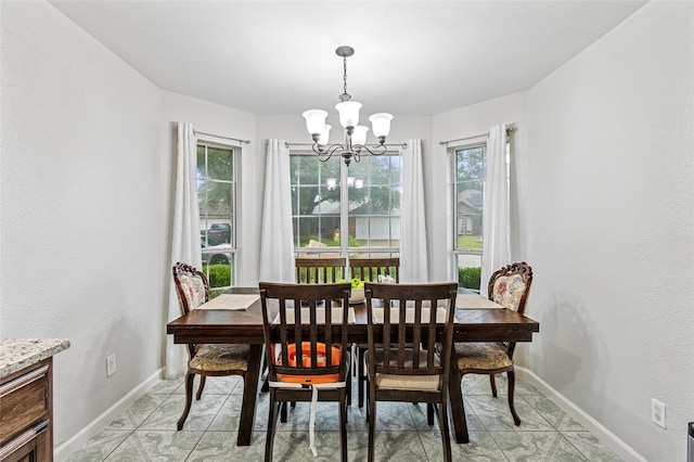 6405 Longmont Trl, Fort Worth, TX 76179 - dining space with a chandelier, baseboards, and light tile patterned floors